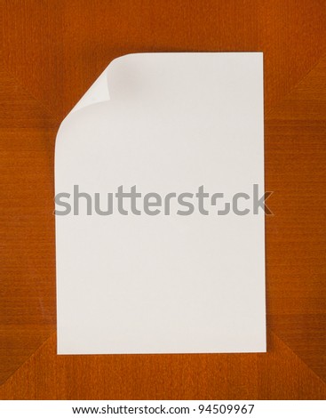Empty paper with angled corner on wooden Background vertical