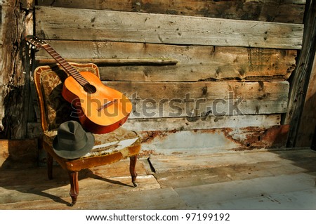 old acoustic guitar on an old armchair horizontal