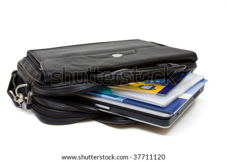 Black leather computer bag with laptop and folders isolated on white background