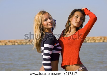 stock photo Two young girls pose on a beach