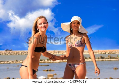 stock photo Two young girls walk on a beach