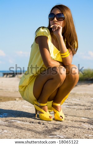 stock photo Swarthy young girl poses on the beach