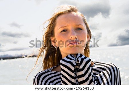 The girl on a beach in bad mood