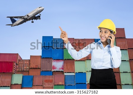 Asian worker with Container Cargo freight ship and Air plan for Logistic Import Export background.
