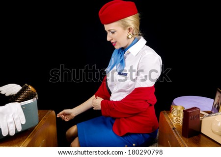 Retro Airline Stewardess or Flight Attendant Removing Her Jacket After Work.