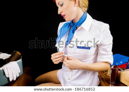 Retro Airline Stewardess or Flight Attendant Removing Her Shirt After Work.