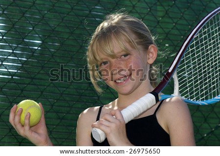 Confident Elementary Age Girl with Tennis Ball and Racket.