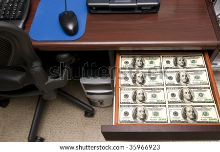 A Desk Drawer Stacked High with Hundred Dollar Bills.