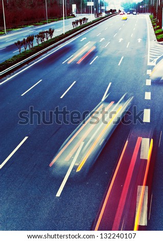 Highway with lots of cars. Blue tint, high contrast and motion blur to rise speed.
