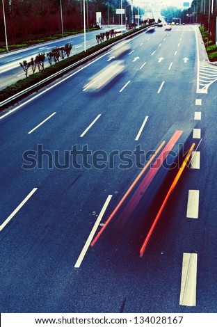 Highway with lots of cars. Blue tint, high contrast and motion blur to rise speed.