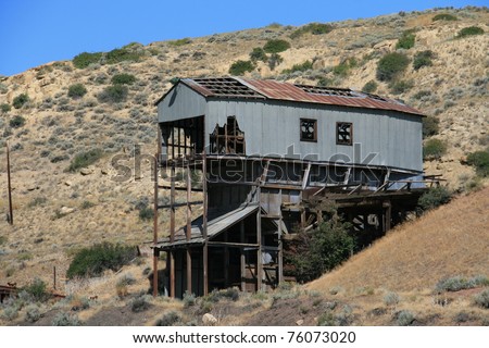 Abandoned metal mining building on a hillside
