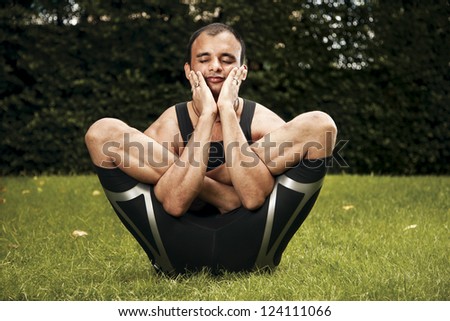 Indian Man performing yoga outdoors smiling peacefully