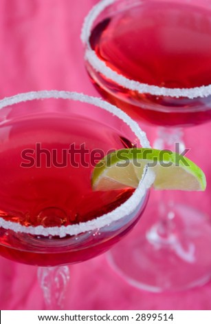 pink cocktails in salt rimmed glasses with lime wedge - narrow DOF
