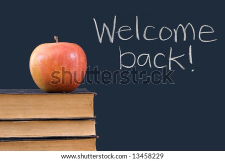Welcome back! written on chalkboard with apple, books