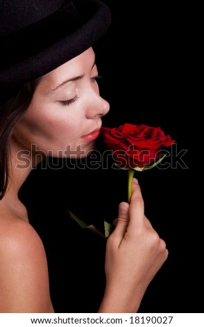 beautiful woman holds single red rose - black background