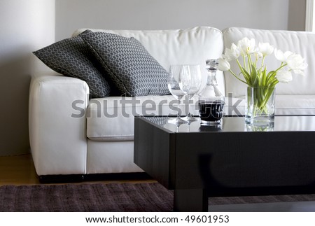white tulips and red wine in modern living room