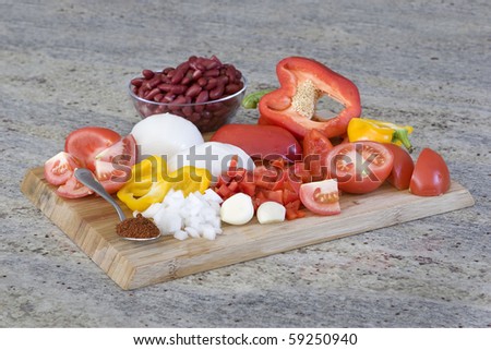 chili ingredients - chopped vegetables on a bamboo cutting board