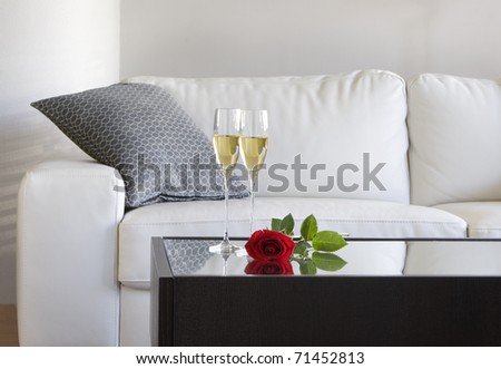 champagne and red rose on table in modern living room