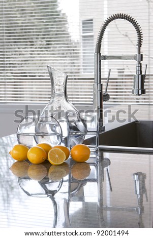 carafes of water and lemons in modern kitchen - freshness