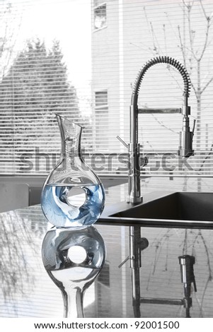 carafe of water in modern kitchen - partially toned image