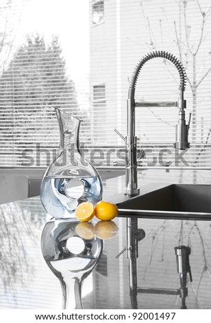 carafe of water and lemons in modern kitchen - freshness