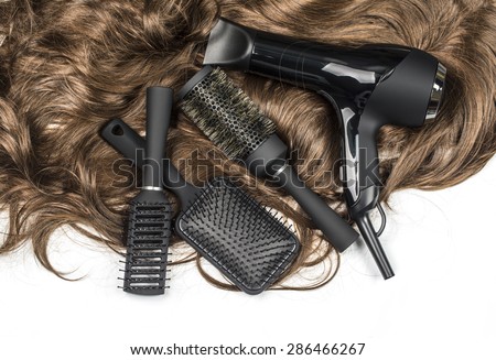 hairdressers tools on a background of the brown hair