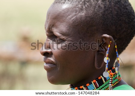 Native Masai woman portrait with traditional jewelry from beside