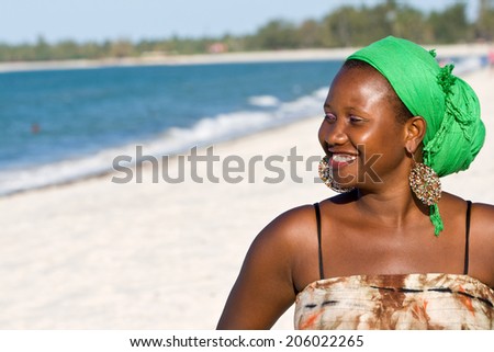 Happy African woman looking to the sea.