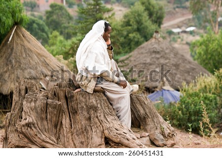 LALIBELA, ETHIOPIA - FEBRUARY 23, 2010: Unidentified religious man sits on a trunk and looks down at the rock-cut churches of Lalibela.