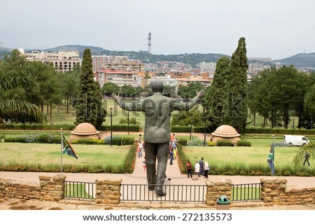 PRETORIA, SOUTH AFRICA - MARCH 22, 2015: Unidentified people take images of the nine meter tall bronze statue of former president Nelson Mandela of South Africa at the Union buildings in Pretoria.