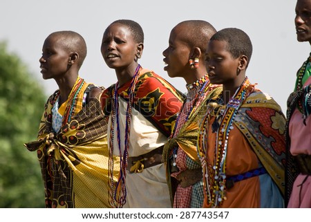 MASAI MARA, KENYA - JULY 12, 2010: Unidentified Masai women sing and dance a traditional performance in their village.