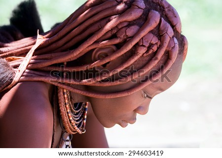 Profile of a Himba woman looking down.