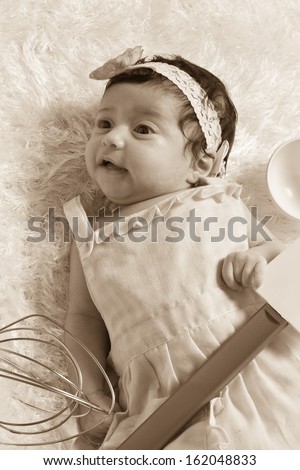 Adorable newborn baby Hispanic girl on a soft white blanket - pink