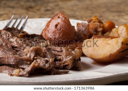 Macro shot of organic grass fed beef roast dinner with red potatoes and carrots