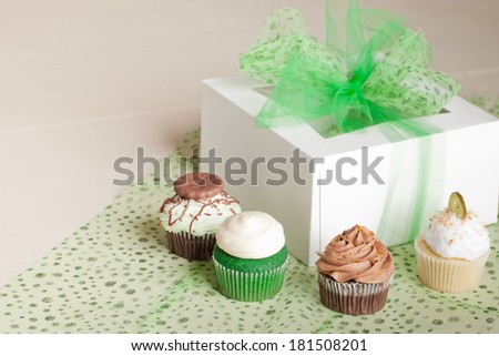 St. Patrick\'s Day gift box with room for writing Coconut Key Lime Cupcake, Pot of Gold Chocolate Caramel Cupcake, Irish Mint Chocolate Cupcake, and Green Velvet Cupcake