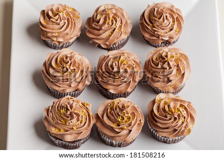 Pot of Gold cupcakes top view - chocolate cake with a rich salted caramel center topped with chocolate buttercream and edible gold stars