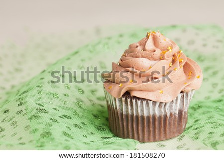 Pot of Gold cupcake horizontal view - chocolate cake with a rich salted caramel center topped with chocolate buttercream and edible gold stars