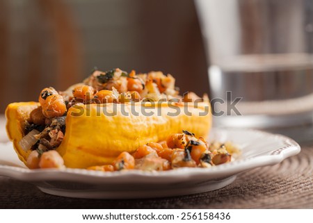 Delicata squash stuffed with chickpeas, kale, and onion