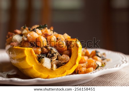 Macro shot of gourmet dish of Delicata squash stuffed with chickpeas, kale, and onion
