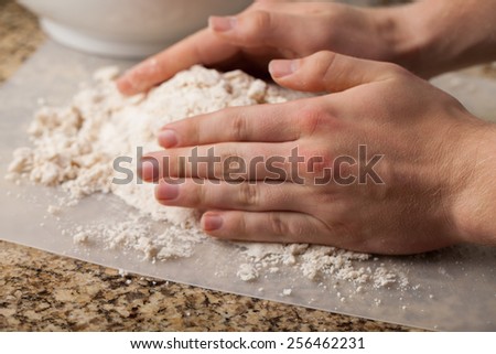 Man making pie crust from scratch - pulling dough together
