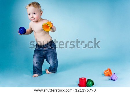 Portrait of a boy with blonde hair. He is play