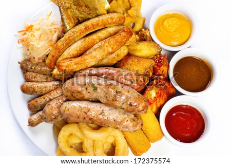 Big beer plate with three different sauce, on a white background
