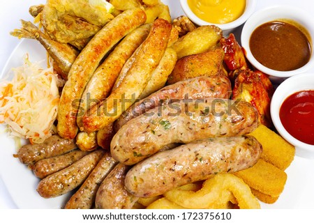 Big beer plate with three different sauce, on a white background
