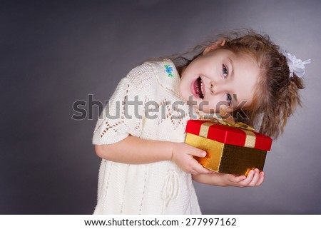 Happiness girl with red gift in her hands, work in studio