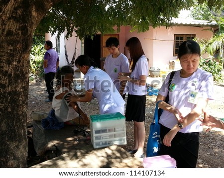 KANCHANABURI, THAILAND - JULY 30: A group of medical students do physical examinations and give knowledge to old people for primary prevention of disease on July 30, 2012 in Kanchanaburi, Thailand