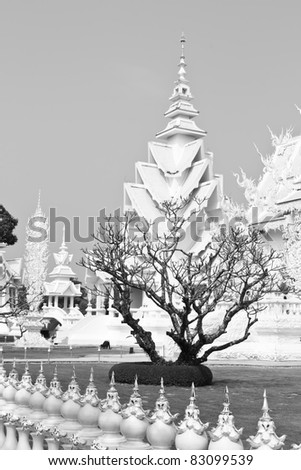 Died tree is in front of white pagoda.