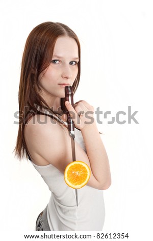 beautiful young girl eating and cut fruit, isolated over white