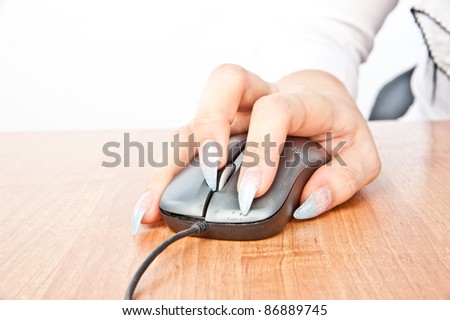beautiful woman\'s hand holding a computer mouse, isolated over white