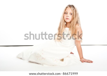 The beautiful girl in a white dress on the isolated white background poses