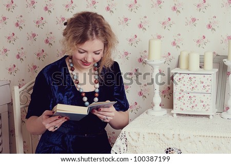 Girl reading book with candle studio shoot